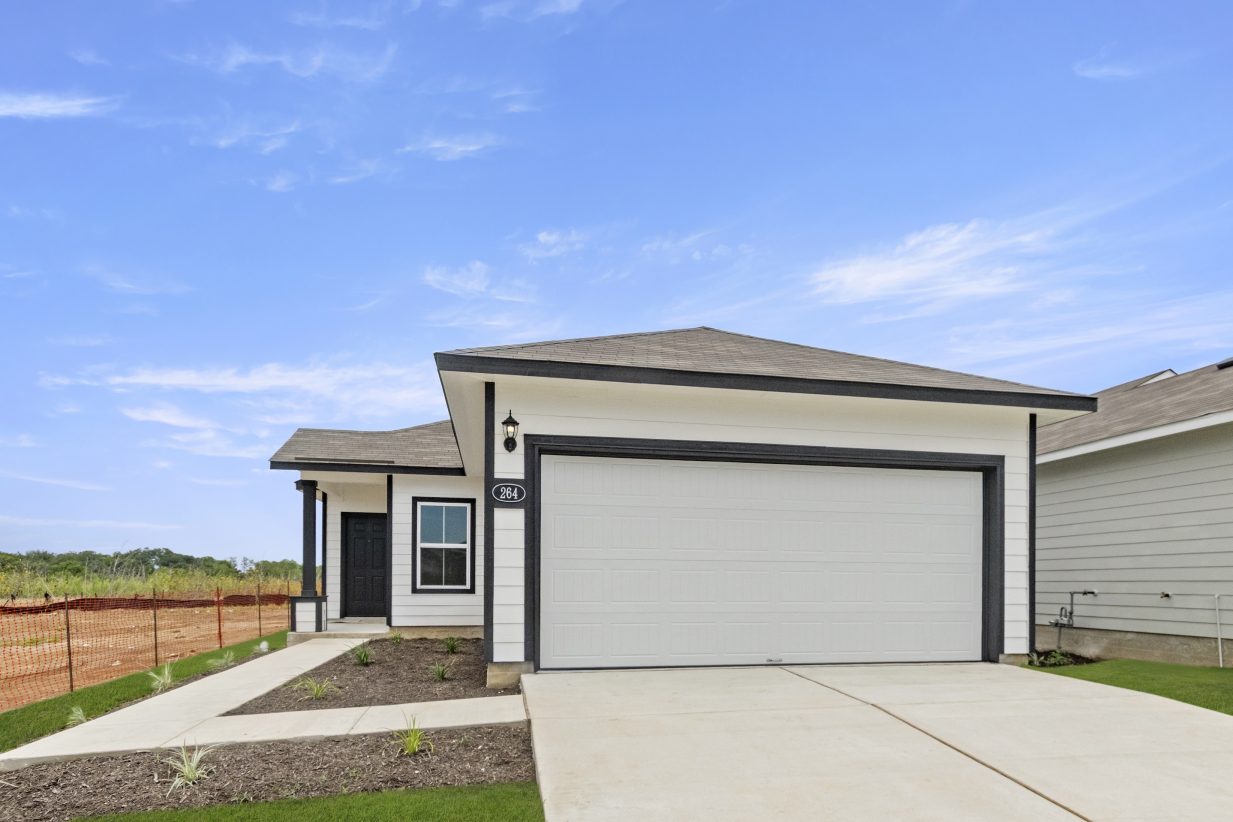 Image of front of a one story black and white home