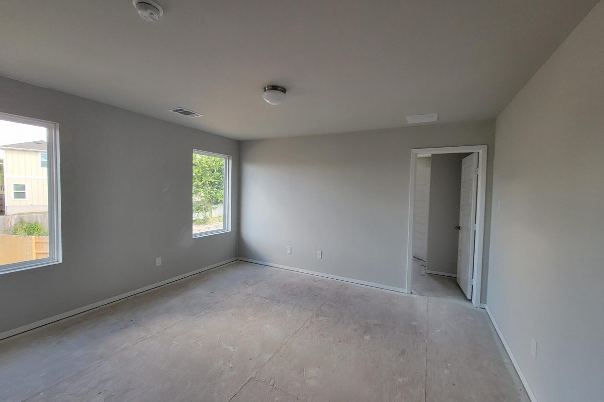 Image of interior of home under construction with white walls and windows